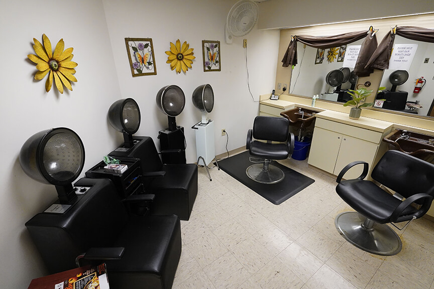 Hood dryers and salon chair in On-site Salon- Arbors at Marietta