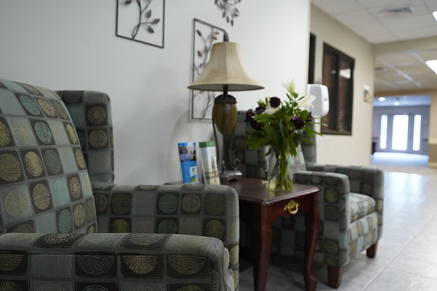 Sofa with table and flower vase in Resident Lounge- Arbors at Marietta